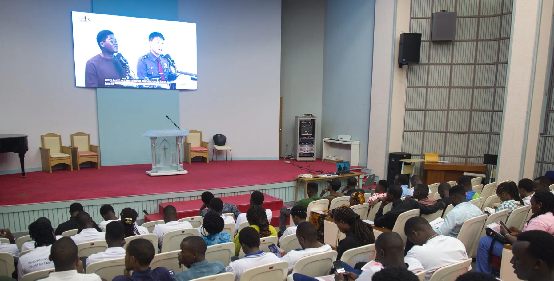 Students watching the crime prevention education video in the chapel