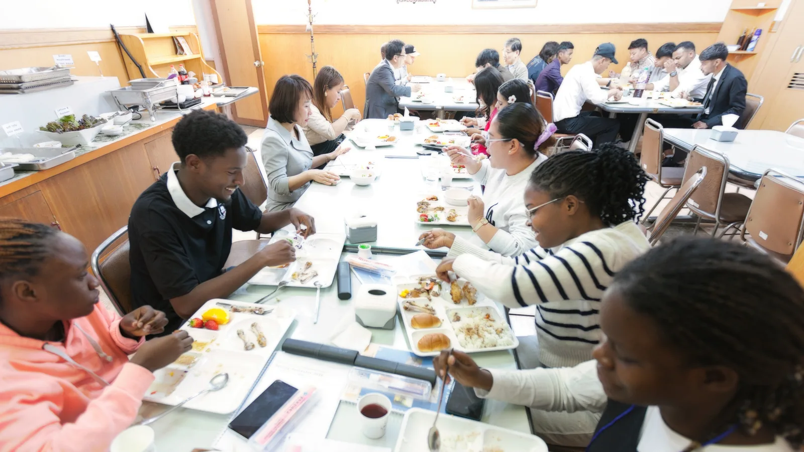 International students and staff sharing lunch together